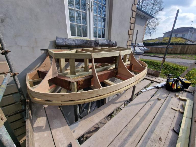 The timber canopy during construction - each piece handmade for the classic 'lead skirt' look