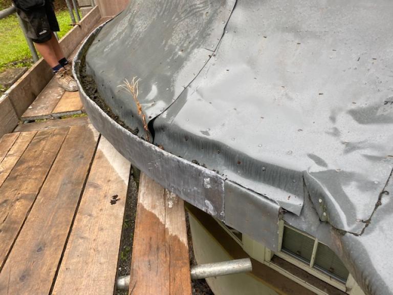 including buckled leadwork, allowing water ingress