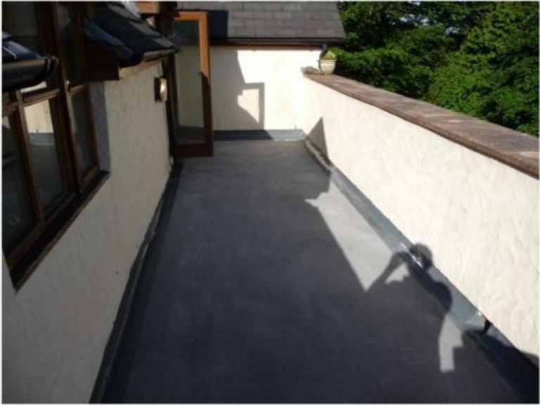 ... and after the 15-year liquid roofing system had been applied